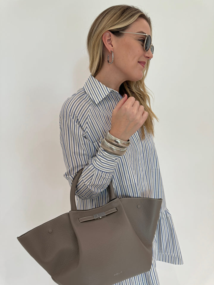 Simkhai Polina Shirt Mini Dress - Cool Gray Stripe with Le Specs Neptune Deux Sunglasses, Alexis Bittar Brut Tube Hoop Earrings in Silver, DeMellier The Midi New York Tote Bag in Stone Grey, BK Silver Cobra Cuff and Bracelet - all available at Barbara Katz