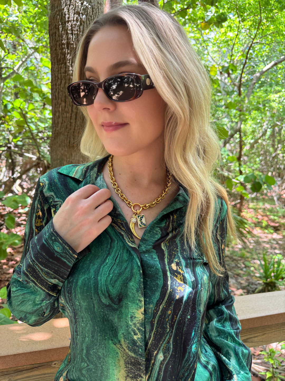 Model wearing Le Specs Unreal! Sunglasses in Toffee Tort, shown with ME369 Joelle Long Sleeve Shirt in Jade and Gold marble print, and Elizabeth Cole Jewelry Kaida Necklace