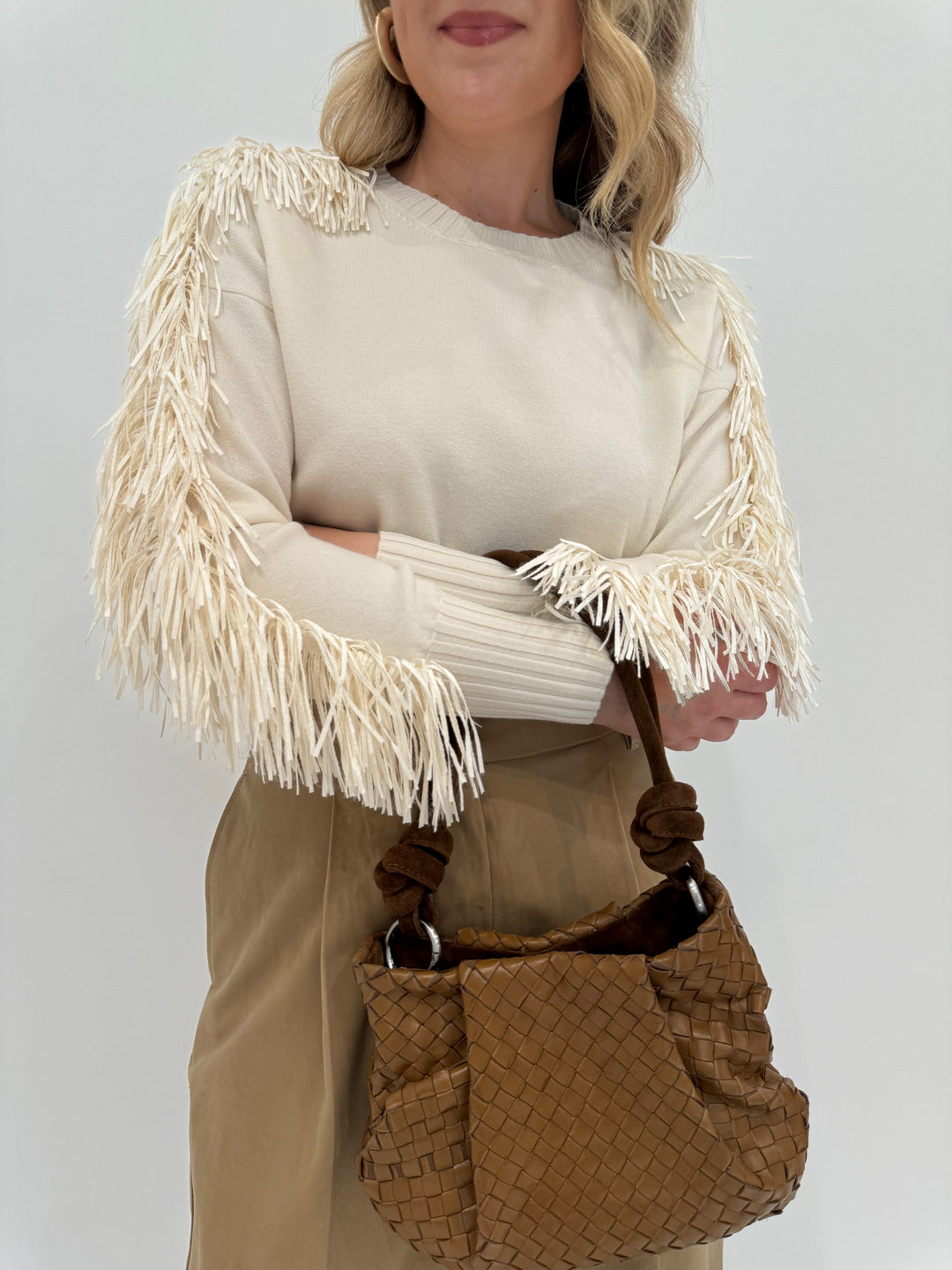 D.Exterior Fringe Sleeve Crew Sweater in Latte shown with Daniella Lehavi Bali Knotted Bag in Caramel Woven available at Barbara Katz