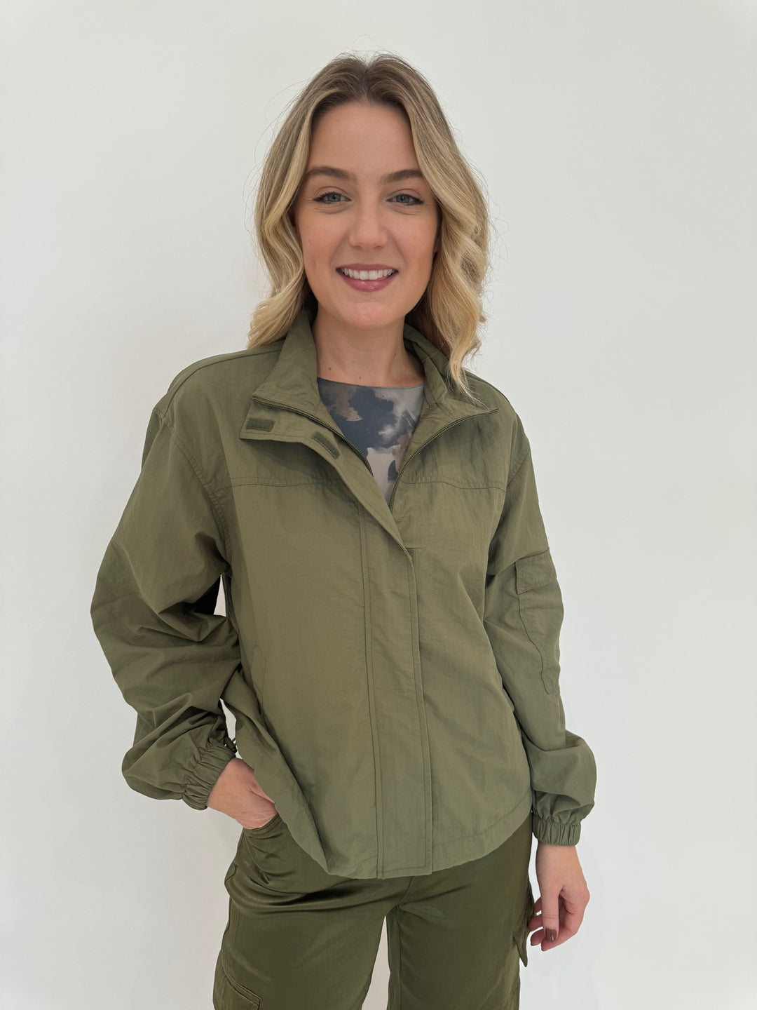 AMB Foliage Second Skin Raw Edge Top in Neutral Gray layered with BK Linda Nylon Cropped Windbreaker in Moss available at Barbara Katz