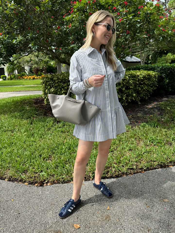 Simkhai Polina Shirt Mini Dress in Cool Gray Stripe with Le Specs Neptune Deux Sunglasses, Alexis Bittar Brut Tube Hoop Earrings in Silver, DeMellier The Midi New York Tote Bag in Stone Grey, BK Silver Cobra Cuff and Bracelet - all available at Barbara Katz