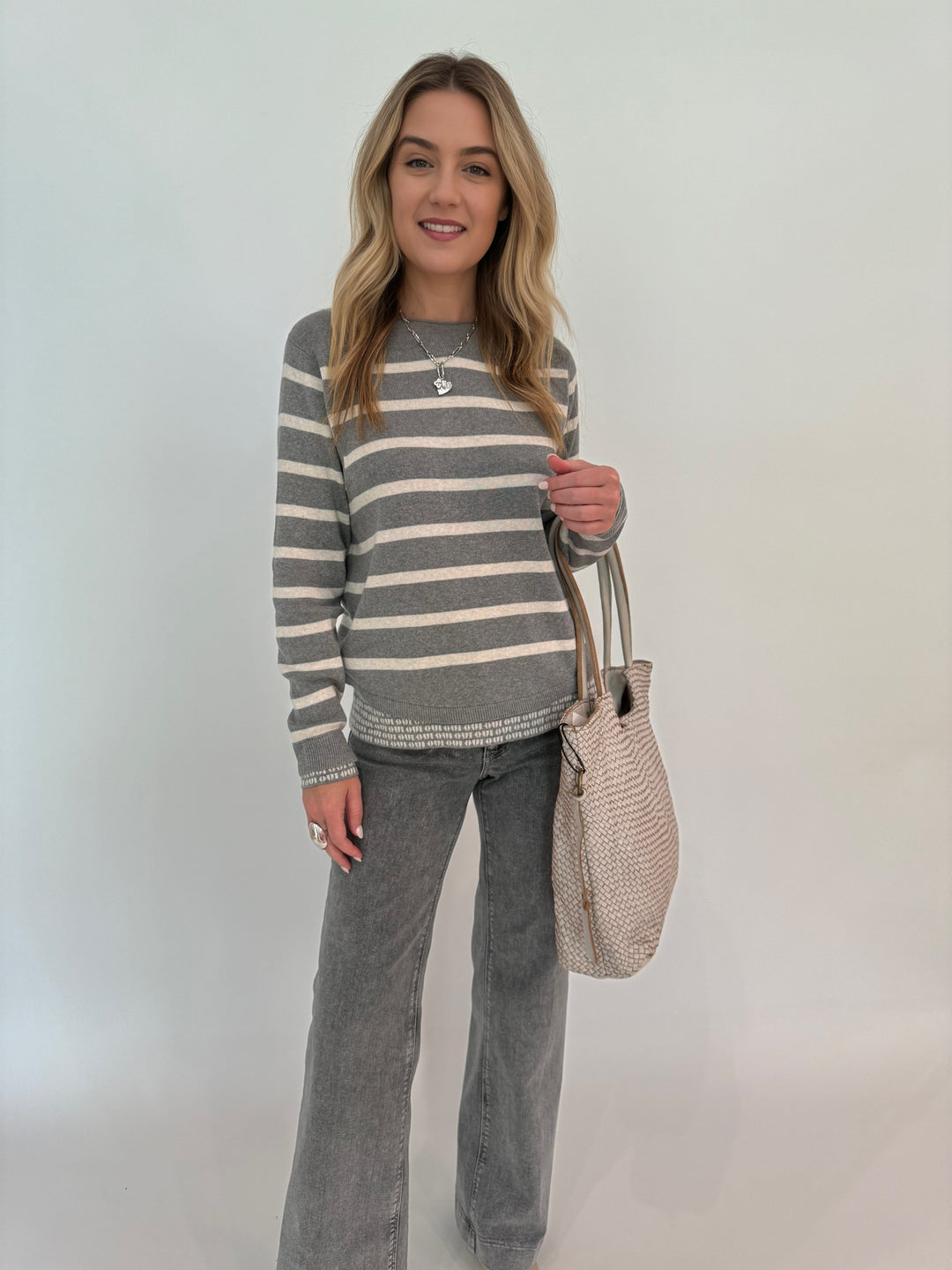 Oui Stripe Double Layer Sweater in Grey/White paired with MAC Dream Boot Jeans in Metallic Silver, bag BK Intrecciato Tote in Beige, all available at barbarakatzshop.com