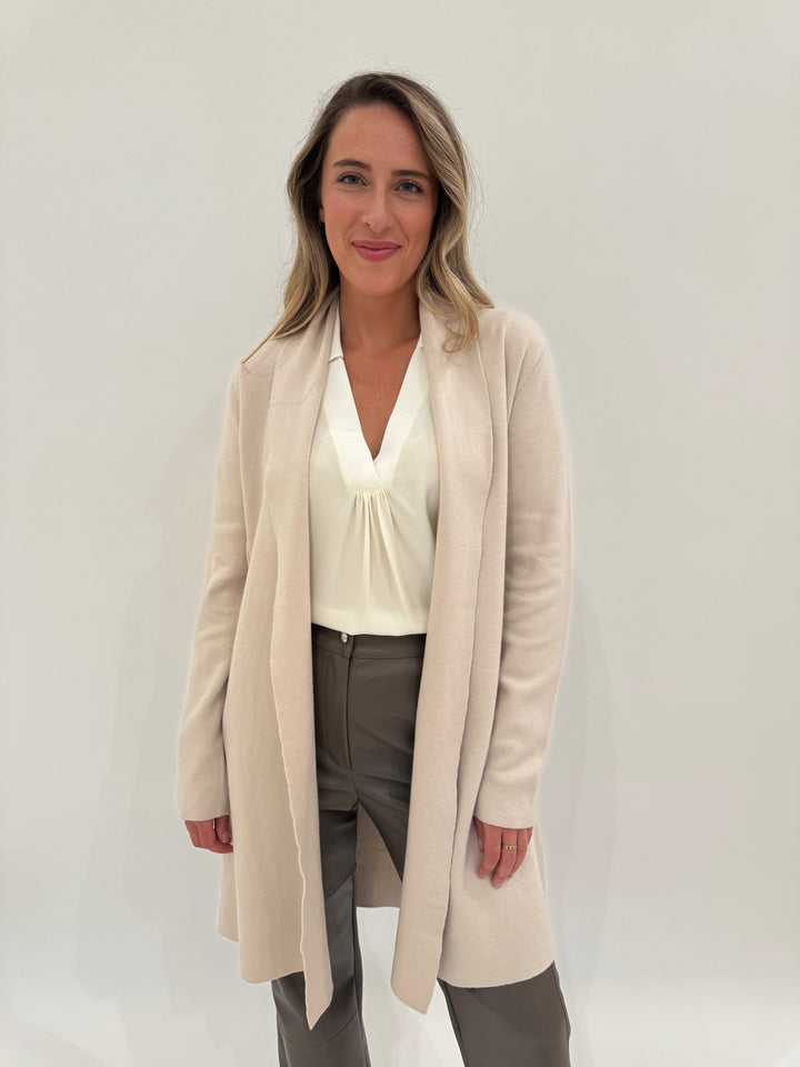 Cinq a Sept Weldon V-Neck Top in Ivory, layered with Pure Amici Willow Long Open Cardigan in Latte, paired with with Max Mara Struzzo Vegan Leather Pants in Hazelnut - all available at Barbara Katz