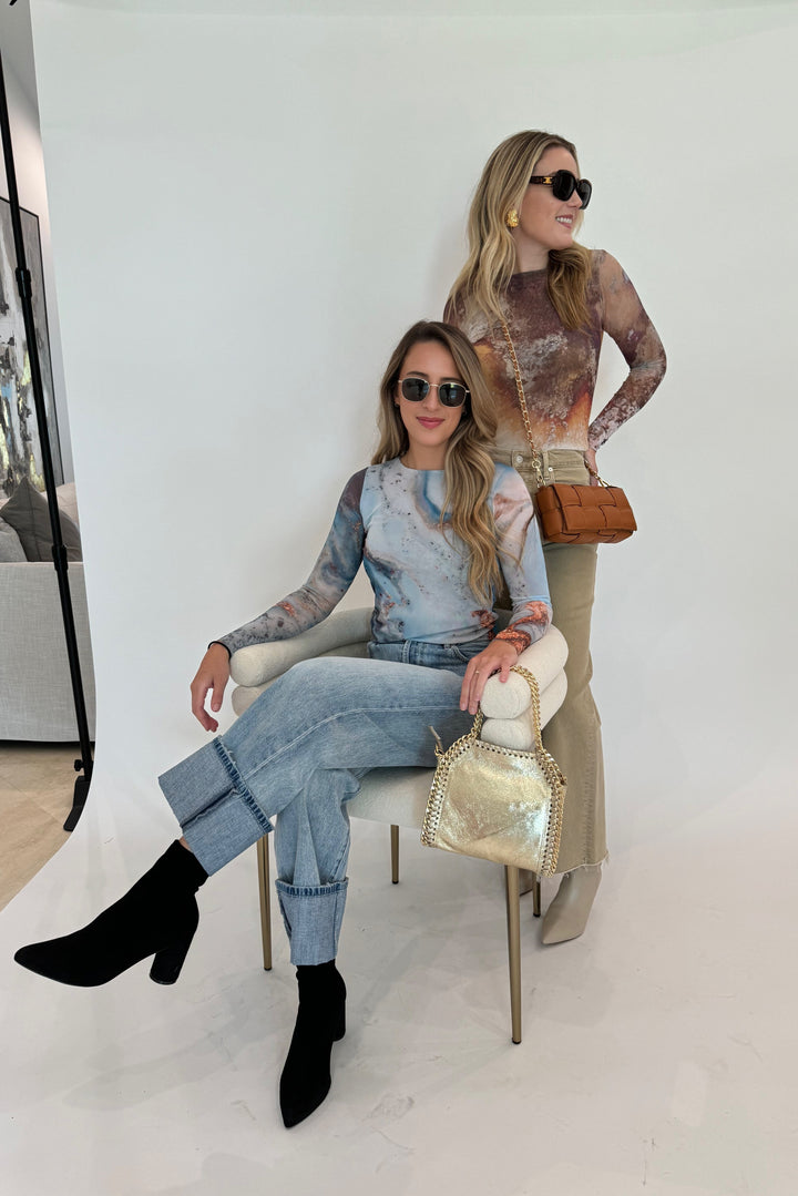 AMB Florence Double Sheer Top in Cavely paired with Citizens of Humanity Lyra Crop Wide Leg Jeans in Porcini, and BK Square Weave Leather Crossbody Bag in Camel, plus AMB Florence Double Sheer Top in Blue Galaxy paired with Pistola Ryder High Rise Cuffed Jeans in Essex, and BK Metallic Luxe Leather Bag in Gold, all available at Barbara Katz