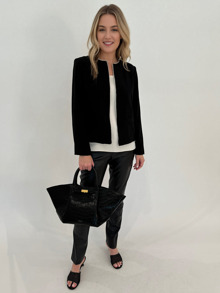 Peace of Cloth Arian Pearl Trim Jacket in Black with White Tank Top underneath, paired with Faux Leather Slim Jeans. bag DeMellier The Midi New York Tote in Black Croc Effect, all available at Barbara Katz