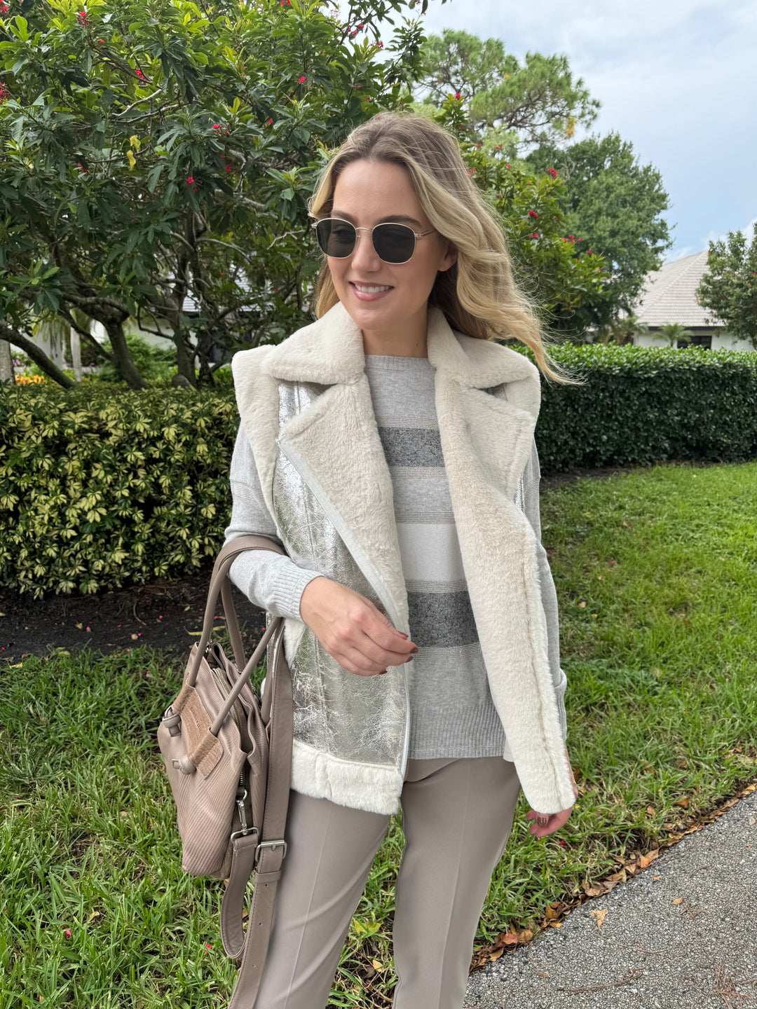 D.Exterior Multi Stripe Crew Sweater in Cenere layered with Metallic Vest in Onice, paired with EW Straight Leg Trouser in Visone, Daniella Lehavi Eveline Satchel Bag in Mocca Stripes, Le Specs Neptune Deux Sunglasses - all available at Barbara Katz