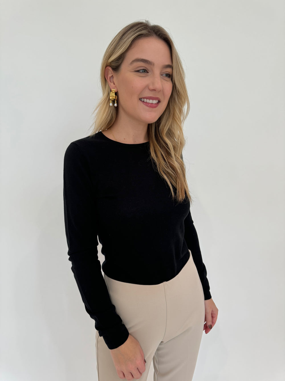 Kinross Fitted Crew Sweater in Black paired with Peace of Cloth Annie Pants in Buff and Alexis Bittar Perla Freshwater Pearl Drop Hoops available at Barbara Katz