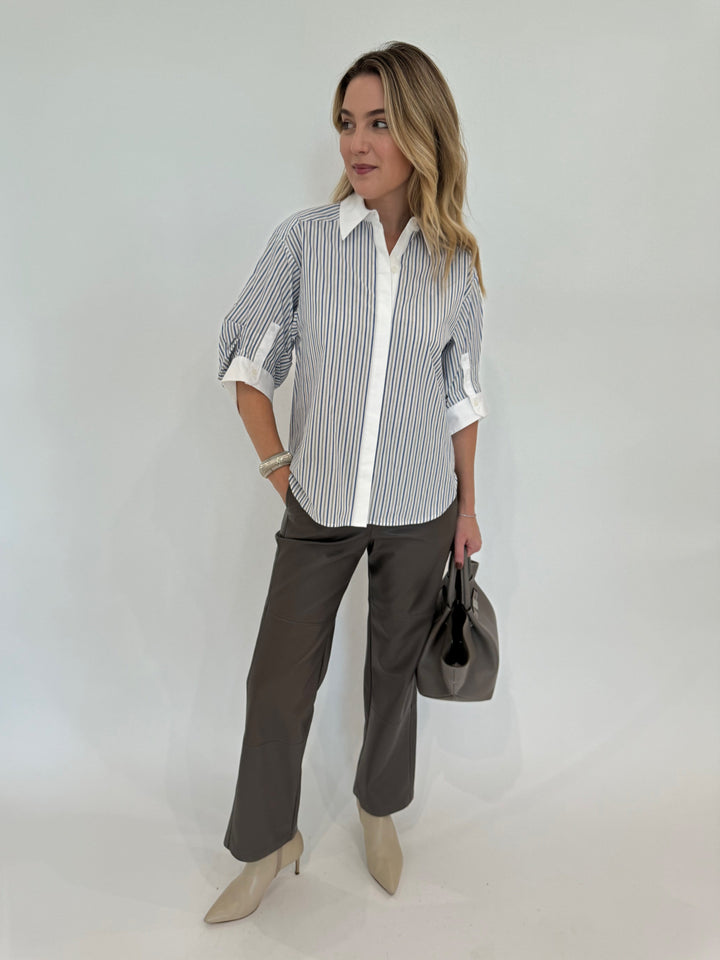 Simkhai Gemma Three-Quarter Sleeve Shirt in Cool Gray Stripe paired with Max Mara Struzzo Vegan Leather Pants in Hazelnut and DeMellier The Midi New York Tote Bag in Stone Gray - all available at Barbara Katz