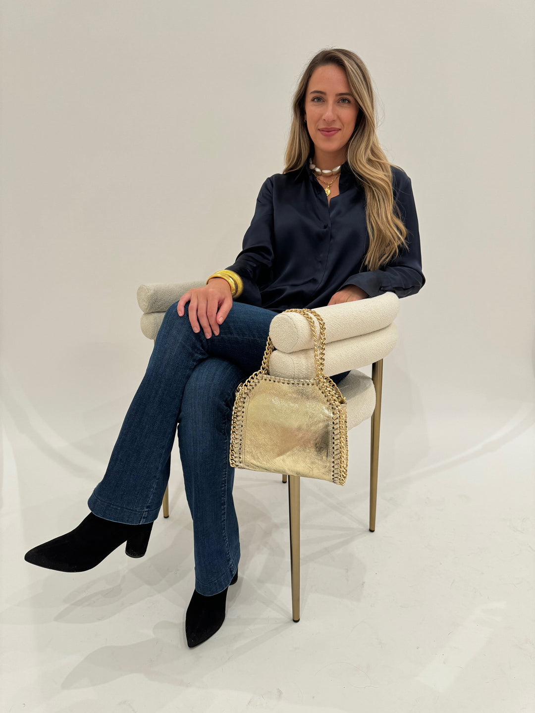 Catherine Gee Daria Silk Shirt in Midnight paired with MAC Denim Dream Boot Jeans in Medium Blue, Lizzie Fortunato Pas De Deux Necklace, BK Gold Cobra Cuff and Bracelet, BK Luxe Metallic Leather Bag in Gold - all available at Barbara Katz
