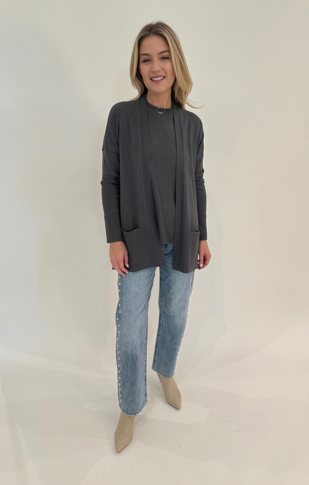 BK Olivia Long Open Cardigan in Tornado with Grey Boxy Sweater underneath, paired with Pistola Lexi Mid Rise Bowed Straight Jeans in Satellite, all available at Barbara Katz