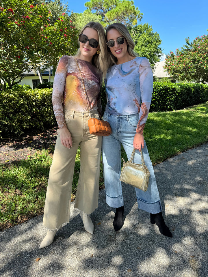 AMB Florence Double Sheer Top in Cavely paired with Citizens of Humanity Lyra Crop Wide Leg Jeans in Porcini, and BK Square Weave Leather Crossbody Bag in Camel, plus AMB Florence Double Sheer Top in Blue Galaxy paired with Pistola Ryder High Rise Cuffed Jeans in Essex, and BK Metallic Luxe Leather Bag in Gold, all available at Barbara Katz