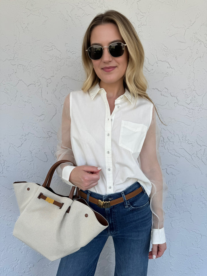 Model wearing Le Specs Neptune Deux Gold Polarized Sunglasses, shown with Cami NYC Pembrok Top with sheer long sleeves, Demelier Midi New York Canvas Bag