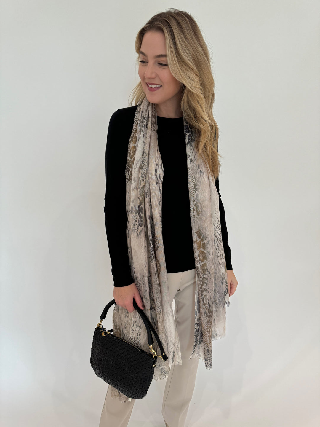 Kinross Cashmere Fitted Crew Sweater in Black paired with Peace of Cloth Annie Pants in Buff and Kinross Python Print Scarf available at Barbara Katz