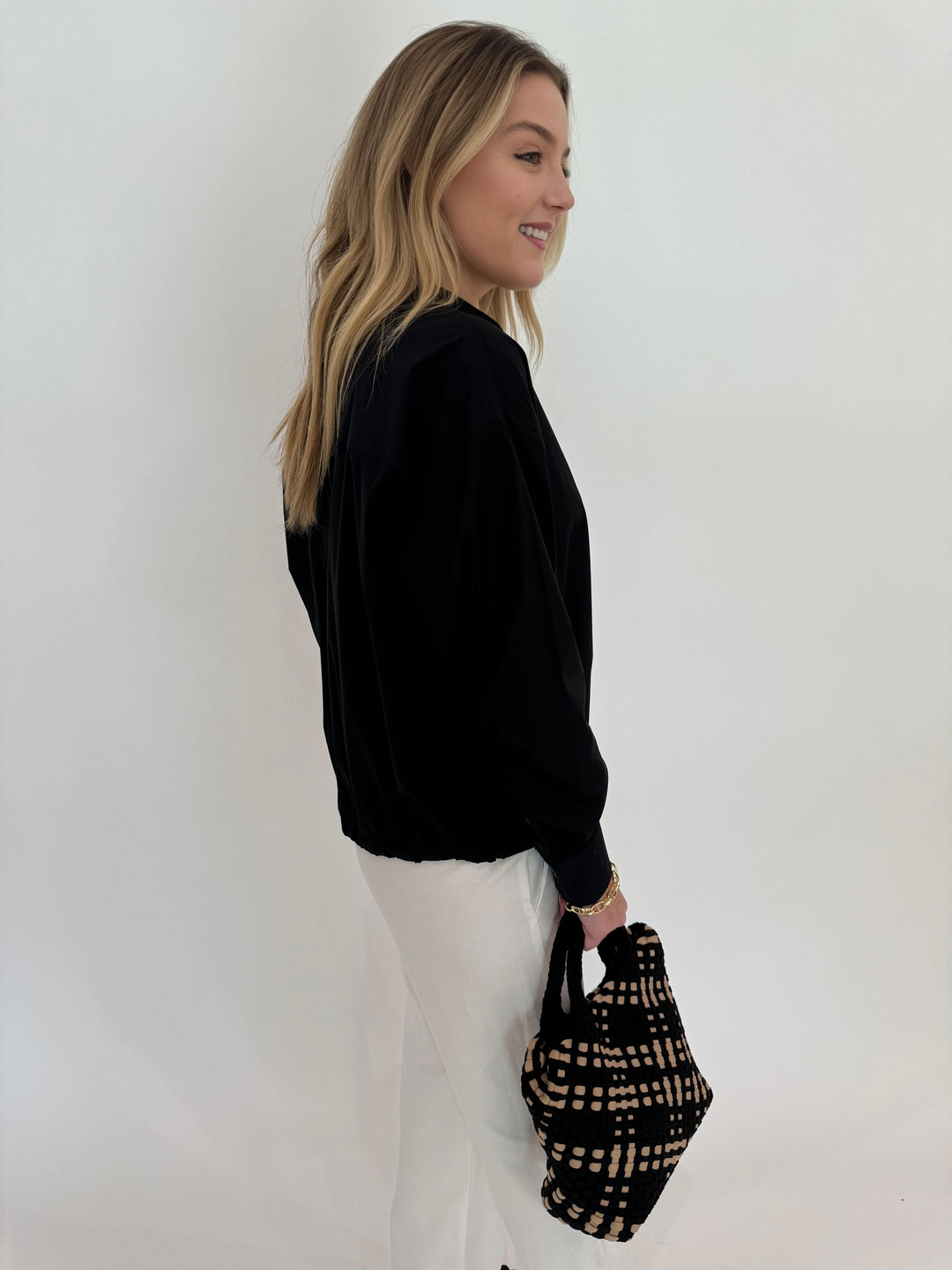 Repeat Tie Waistband Long Sleeve Blouse in Black paired with Enza Costa Twill Everywhere Pant in Off White and Sol and Selene Sky's The Limit Small Bag in Black/Nude