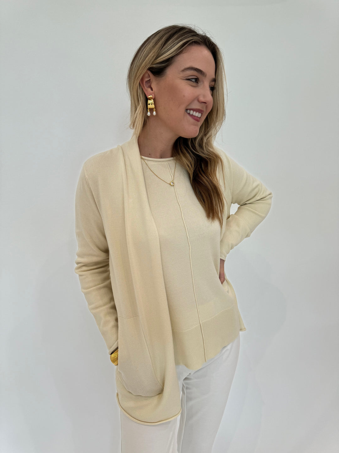 BK Ivory Olivia Long Open Cardigan with Stella Roll Crew Neck Sweater underneath, BK Gold Cobra Bracelet, Alexis Bittar Asterales Necklace and Perla Freshwater Pearl Drop Hoops - all available at Barbara Katz