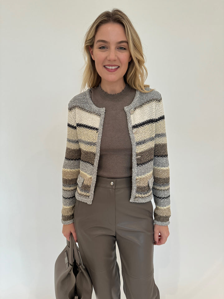 Oui Luna Lettuce Edge Sweater in Smoky Taupe layered with Chunky Knit Crop Cardigan, paired with Max Mara Struzzo Vegan Leather Pants in Hazelnut, DeMellier The Midi New York Tote Bag in Stone Grey -all available at Barbara Katz