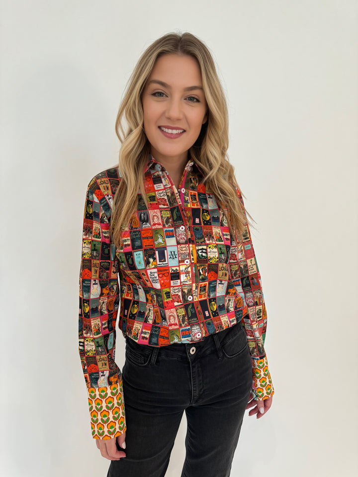 Dizzy-Lizzie Rome Button Down Shirt in Book Club Print paired with black denim pants available at Barbara Katz