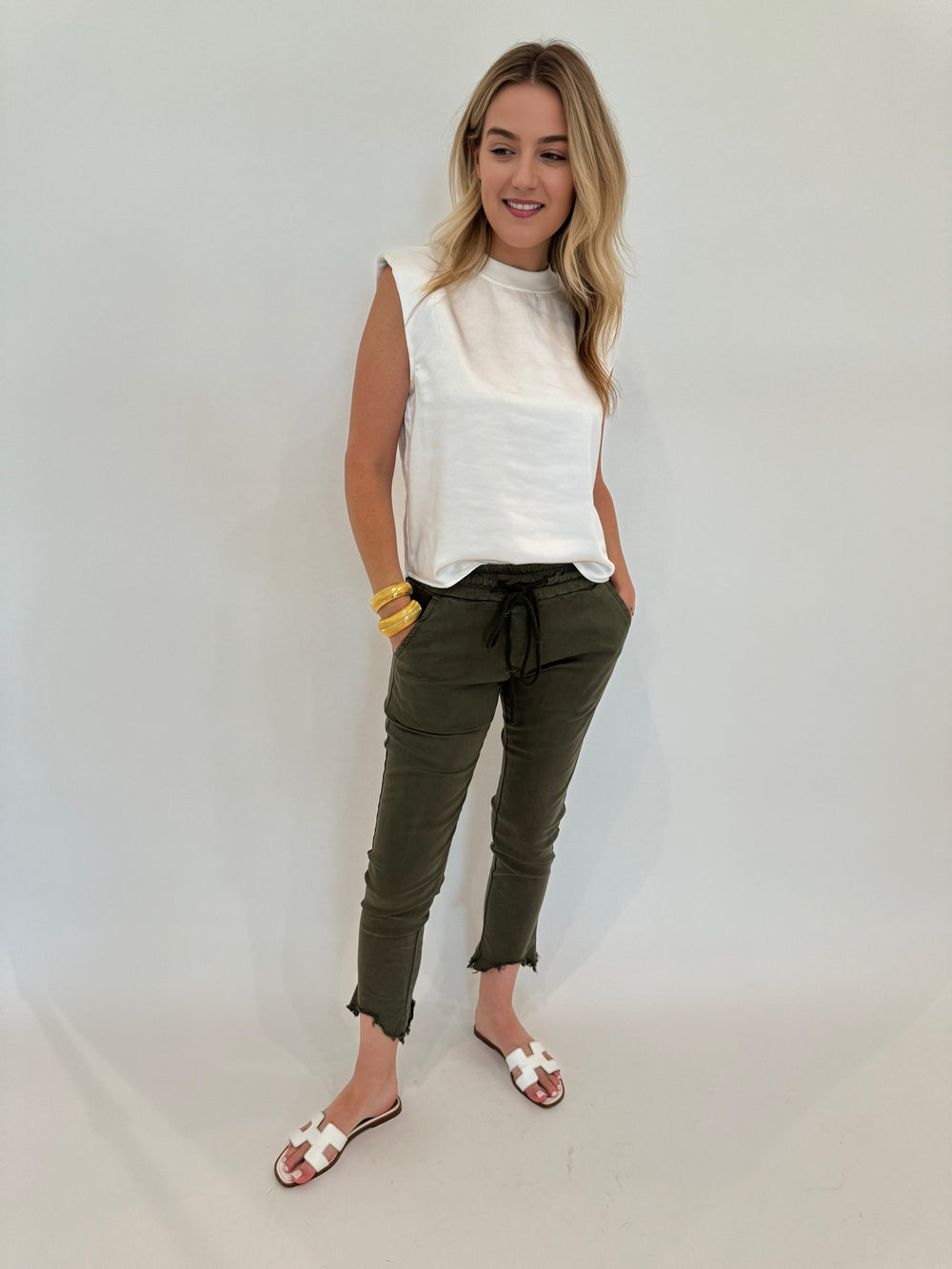 Melissa Nepton Helora Satin Top in Off White paired with BK Kylie Distressed Fringe Hem Crinkle Jogger in Army Green available at Barbara Katz