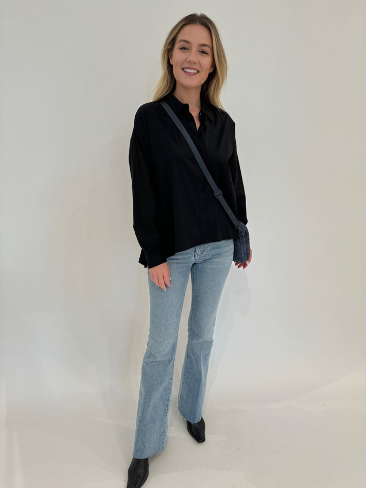 Repeat Blouse With Side End Slits in Black paired with Frame Le Easy Flare Raw Fray Jeans and Sol and Selene Divide & Conquer Woven Crossbody Bag in Denim