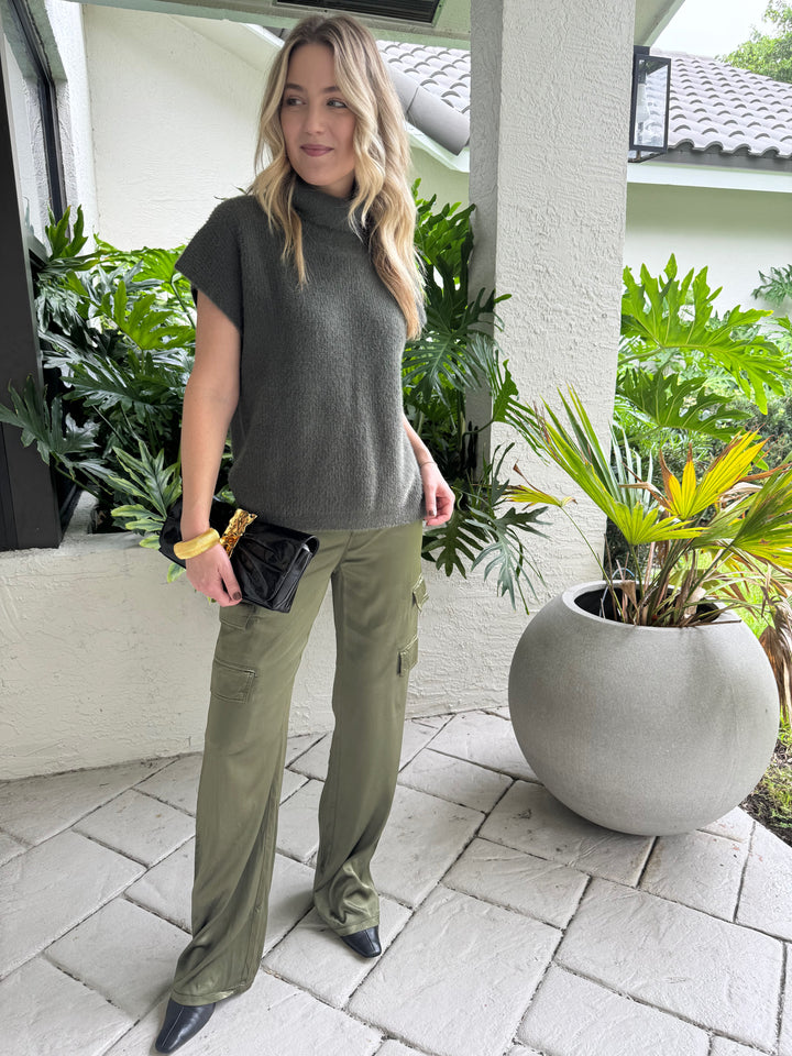 Melissa Nepton Jack Turtleneck Sweater in Winter Moss paired with Marrakech Zendaya Silky Cargo Pants in Pine, BK Gold Cobra Bracelet, and Alexis Bittar Gold Ribbon Convertible Shoulder Bag in Black - all available at Barbara Katz