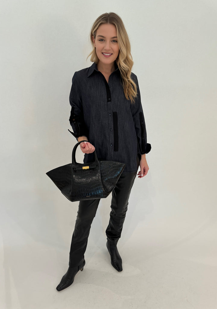 Ozai N Ku Emily Button Down Shirt in Denim paired with Peace of Cloth Black Faux Leather Slim Jeans, and bag DeMellier The Midi New York Tote in Black Croc Effect available at Barbara Katz