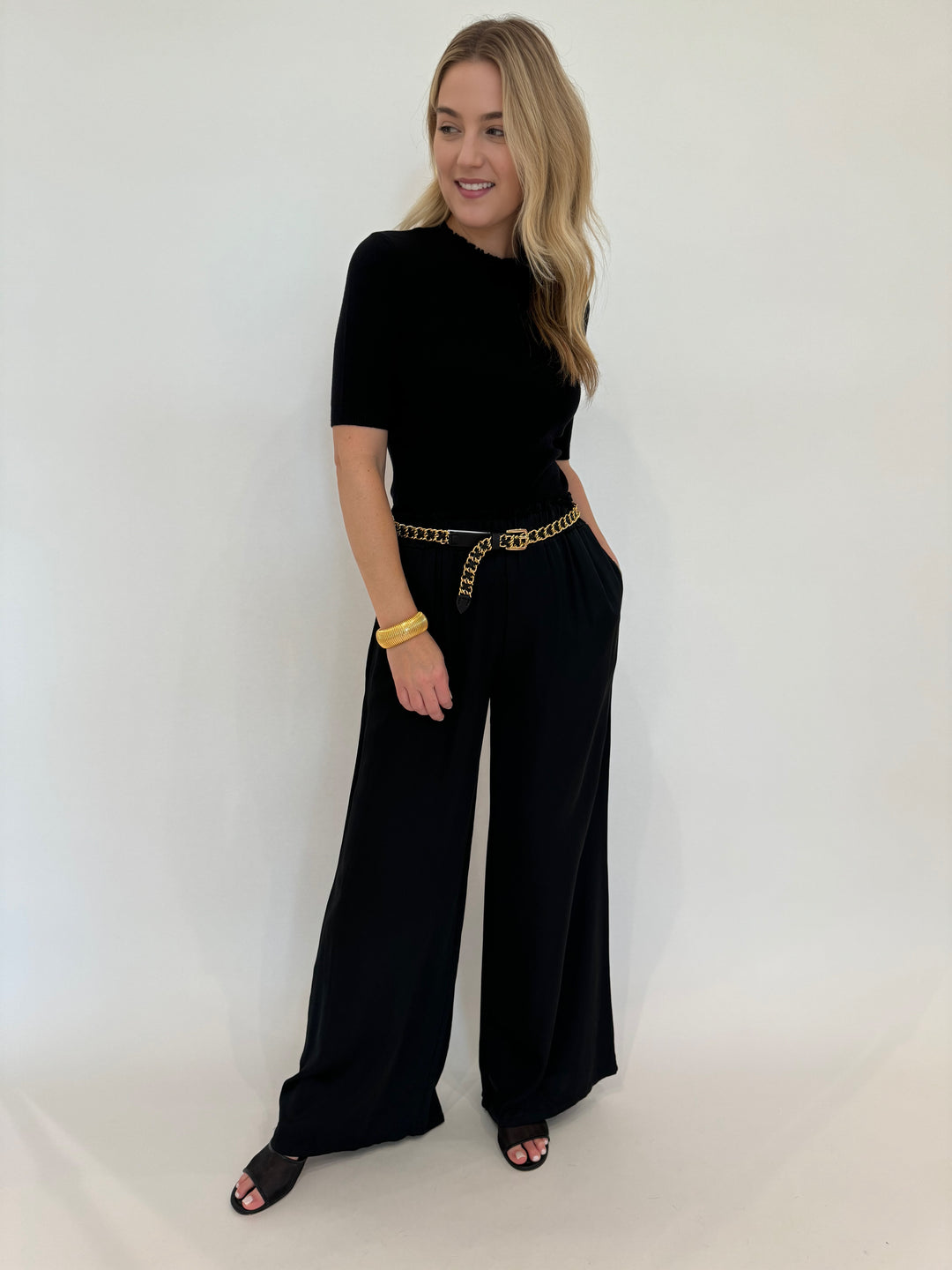 Oui Luna Ruffle Edge Short Sleeve Sweater in Black paired with BK Italian Silky Palazzo Pants available at Barbara Katz