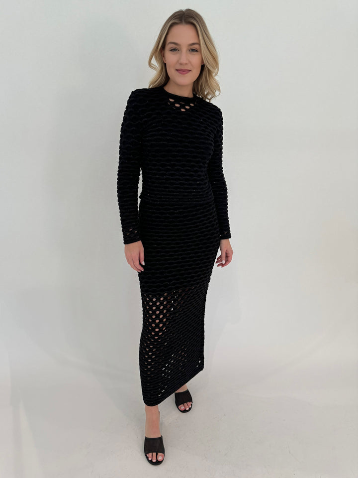 Maria Pavan Mira Crew Neck Wave Sequin Sweater in Black with AMB Black Solid Crew Neck Second Skin Top underneath, paired with Lyra Wave Sequin Midi Skirt, all available at Barbara Katz