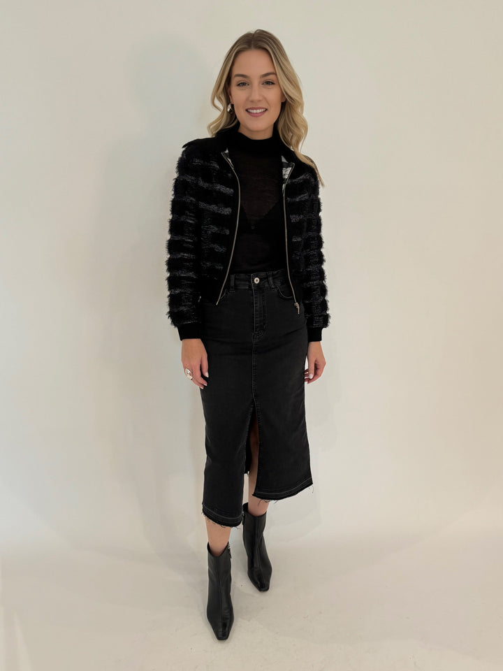 Maria Pavan Ellie Fringe Check Zip Up Sweater in Black/White with Aldomartins Black Norin Top underneath, paired with Elliott Lauren Black Jean Midi Skirt, all available at Barbara Katz