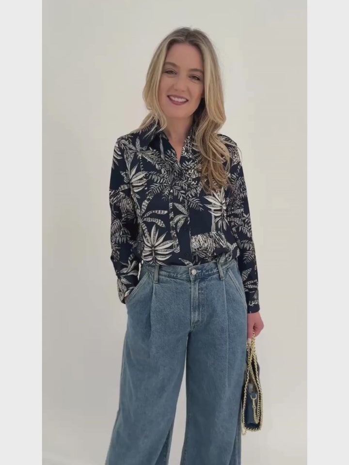 Vilagallo Mafalda Jungle Print Shirt in Navy Blue paired with Agolde Ellis Wide Leg Trousers, BK Metallic Luxe Chain Leather Bag in Denim Blue- all available at Barbara Katz